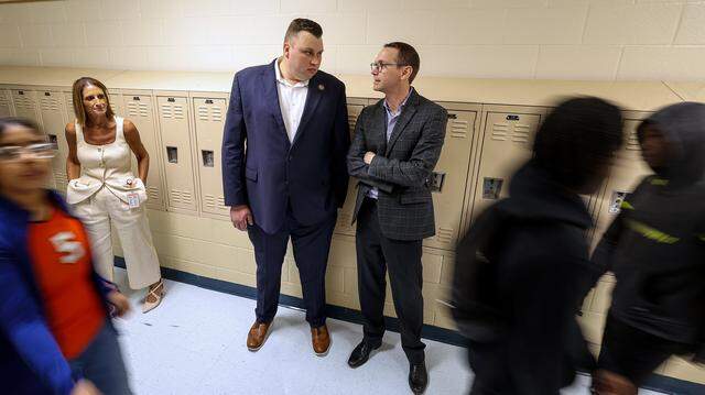 State Education Commissioner Mike Morath, right, talks with  State Board of Education Member Brandon Hall while touring William James Middle School on Thursday, Aug. 28, 2025, in Fort Worth.